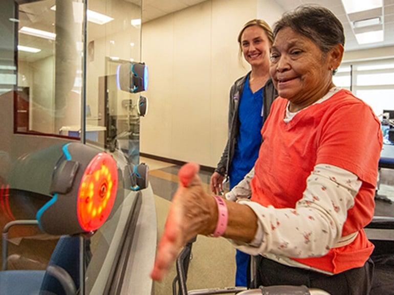 A patient and her therapist work on visual and cognitive rehabilitation utilizing advanced brain injury technology.