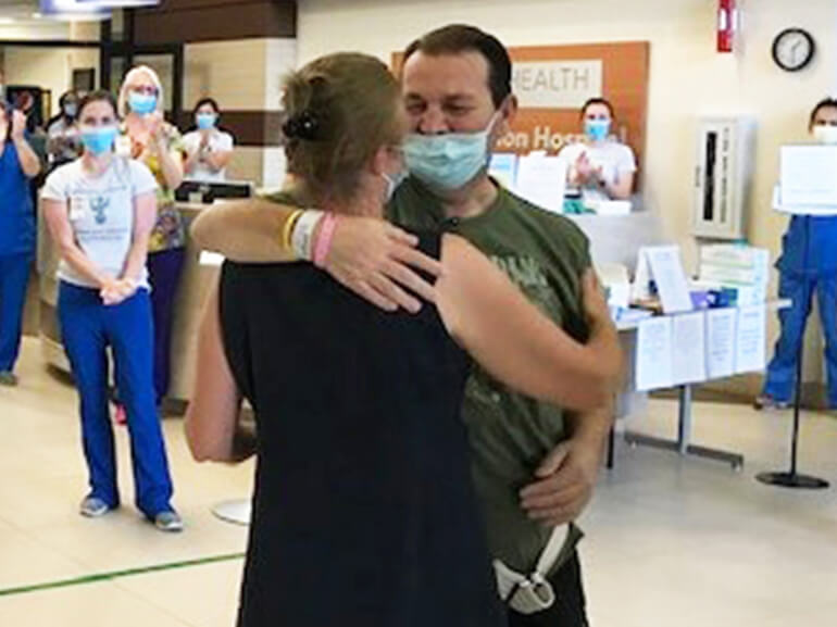 Ennis hugs his wife Olivery on discharge to go home.